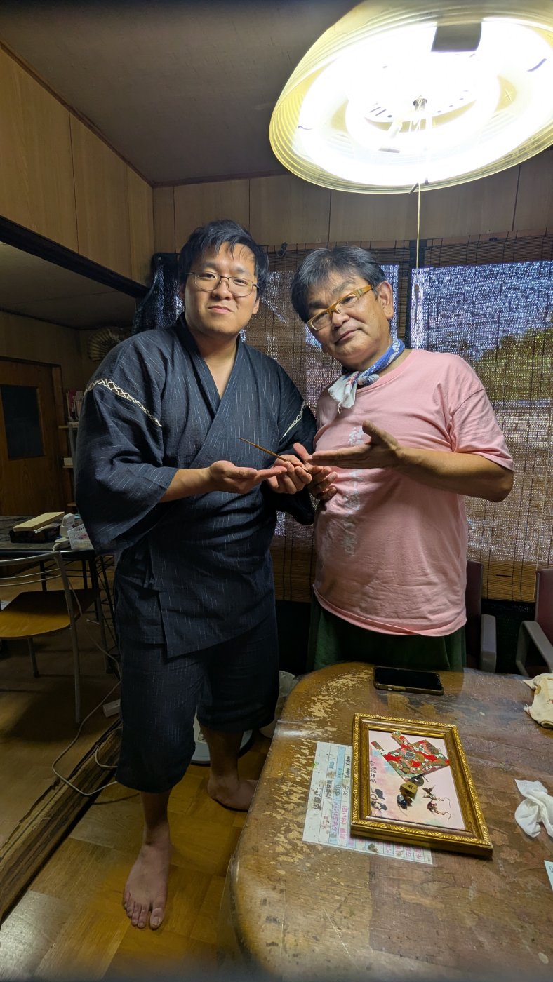 Skyler in yukata with a local craftsman in his studio