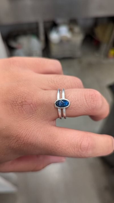 Double Banded Labradorite Ring worn on a hand, bezel-set blue labradorite on a split band