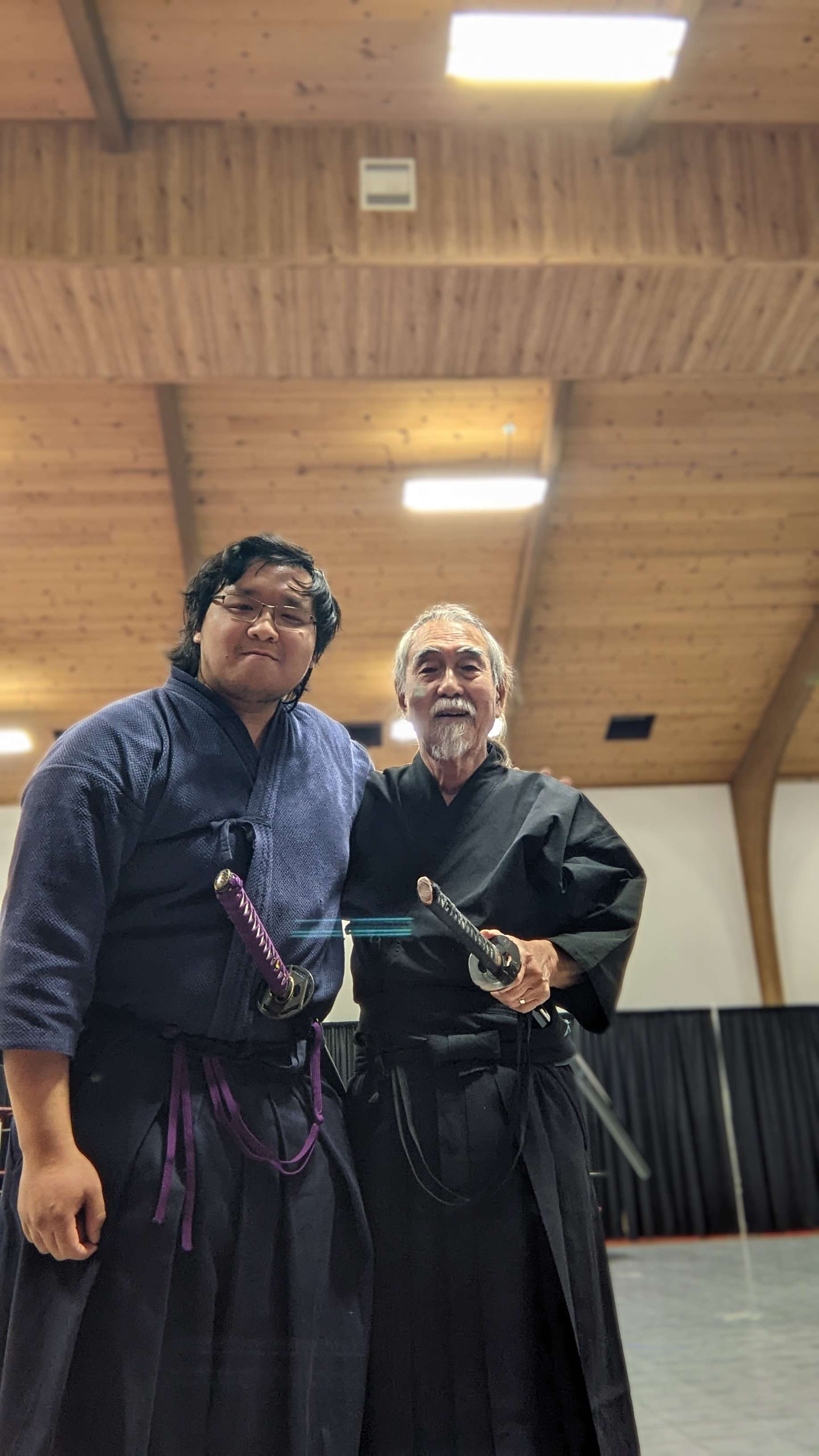 Iaido sword form performed in a dojo, blade drawn at the ready