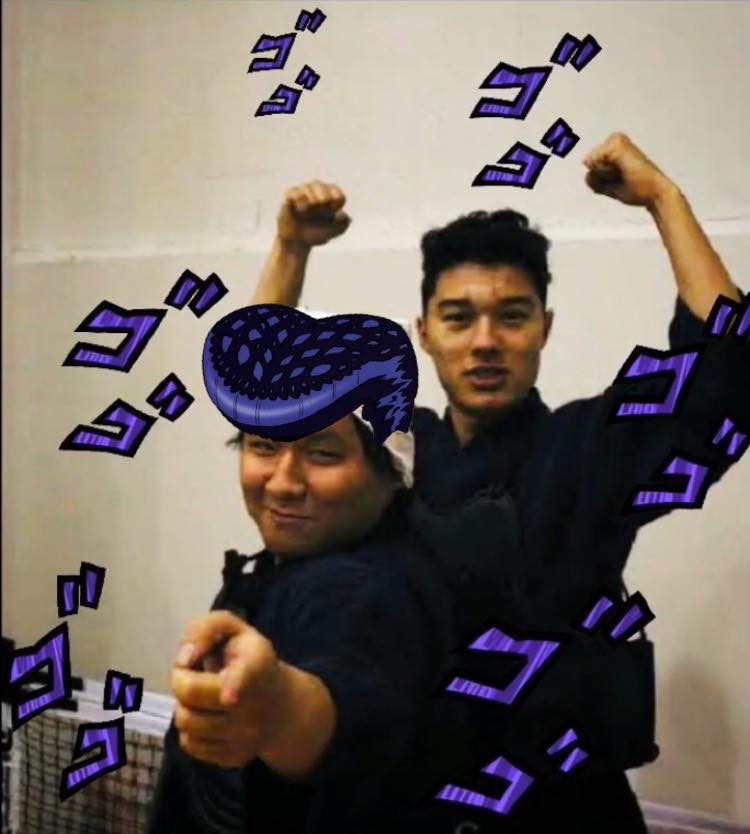 Two kendoka in bogu armor celebrating after training