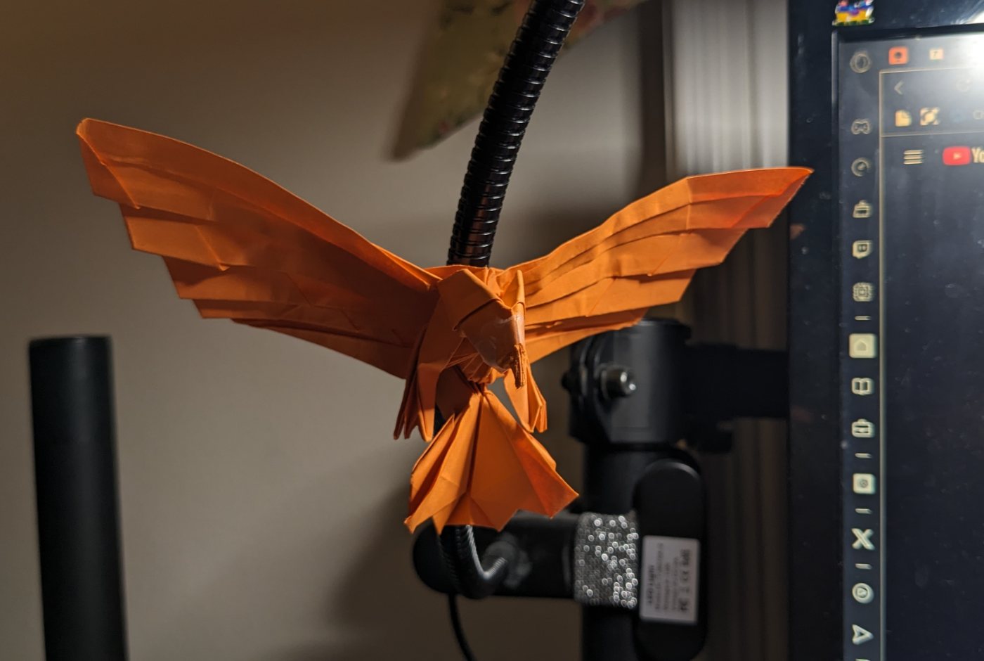 Orange origami eagle with spread wings