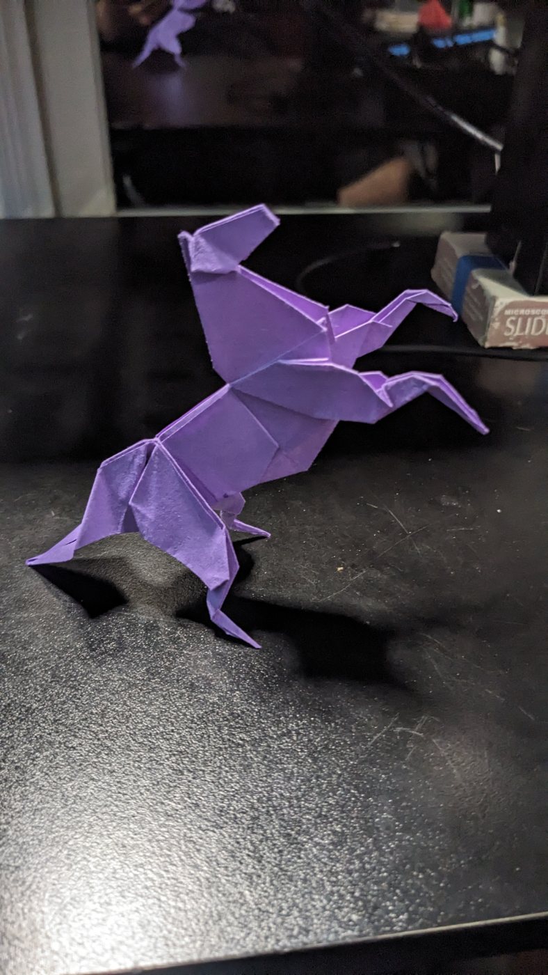 Purple origami rearing horse