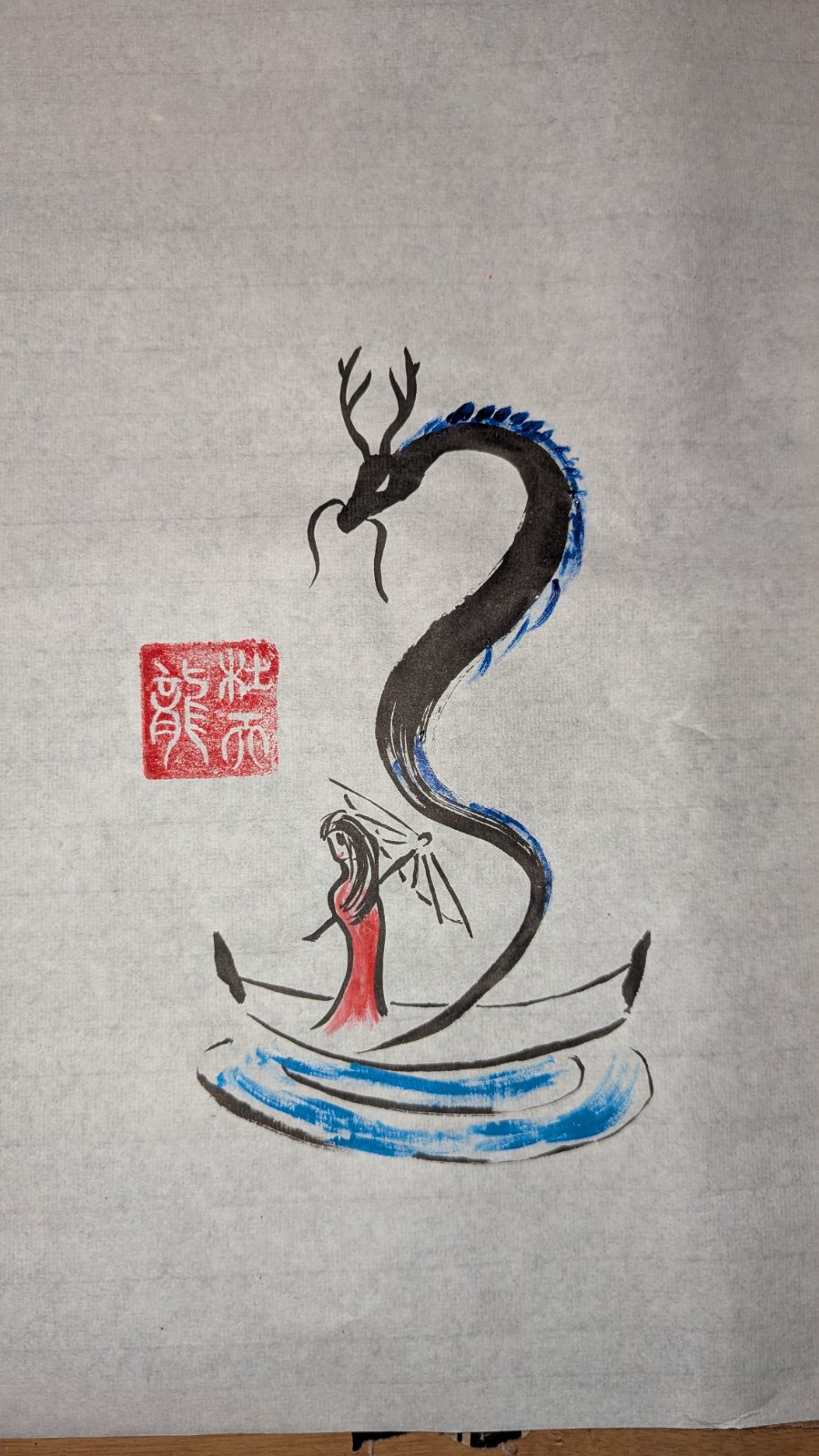 Sumi-e of a black dragon with blue scale accents coiled above a red-robed kimono figure on water, with a red seal